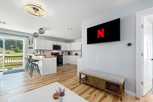 a kitchen and living room with a n on the wall at Platte River Play Lovely 2bdr Barnhouse 2852 in Beulah
