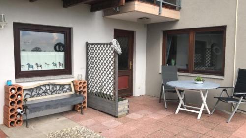 a patio with a table and a table and chairs at FEWO Ostseeland in Grömitz