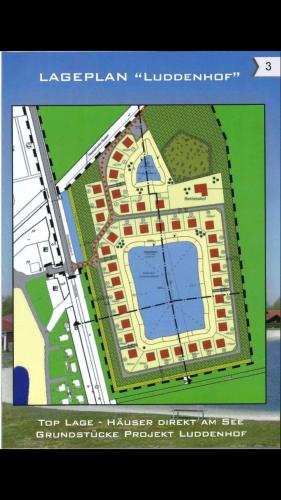 a plan of a large building with a pond at Ferienhaus Seeblick in Walchum