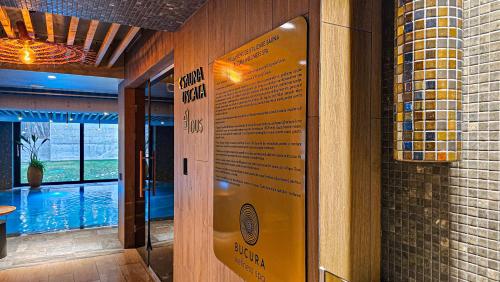 a door to a restaurant with a sign on it at Hotel Bucura in Călimăneşti