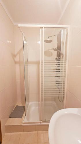 a bathroom with a shower and a toilet and a sink at Apartment in Vilamoura with pool in Quarteira