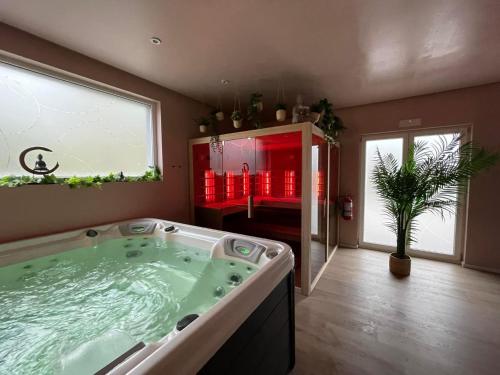 a large bathroom with a jacuzzi tub in a room at Bulles d evasion in La Louvière