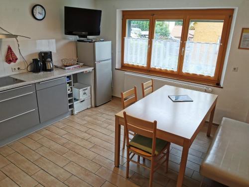 a kitchen with a table and a table and chairs at Haus Post in Todtnau
