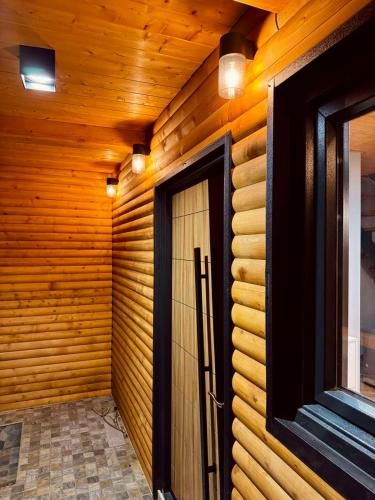 a wooden wall with a door in a room at Mount Apartments in Mavrovo