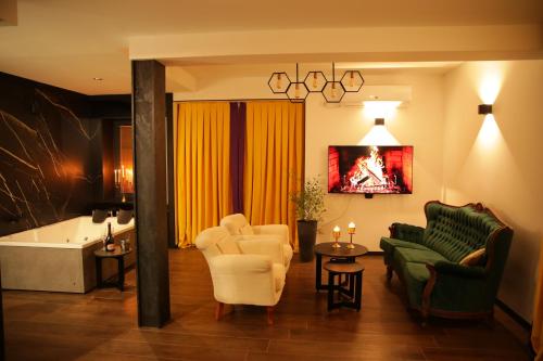 a living room with a couch and chairs and a tub at LION Apartments - DEBAR MAALO in Skopje