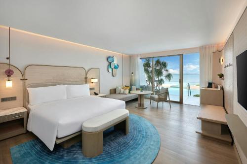 a bedroom with a bed and a living room at Veranda Resort Phuket, Autograph Collection in Panwa Beach