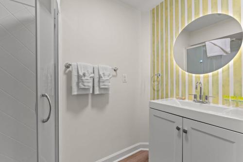 a bathroom with a sink and a mirror at TreeHouse Lodge Walk to Beach Pet-Friendly 103 in Myrtle Beach