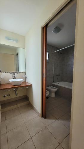 a bathroom with a sink and a tub and a toilet at Casa de Miramar in Miramar