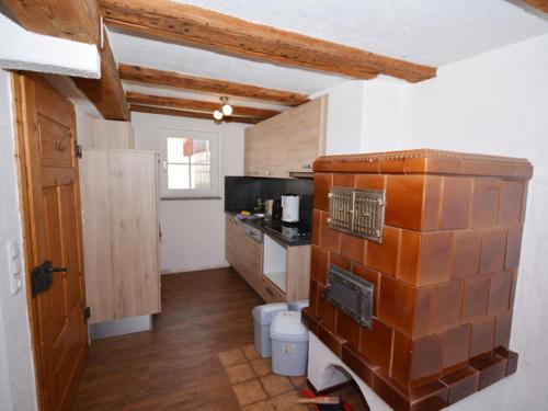 a kitchen with wooden cabinets and a counter top at Alte Schusterei in Colmberg
