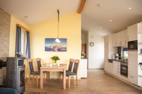 a kitchen and dining room with a table and chairs at Ferienhaus Strandnixe in Dorum Neufeld