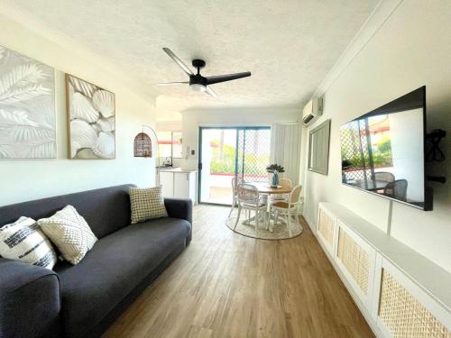 a living room with a couch and a table at Marine Views in Gold Coast
