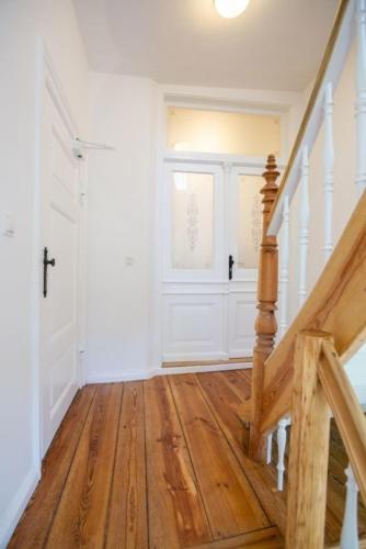 an empty hallway with a staircase and a window at Apartment No3 in Stralsund