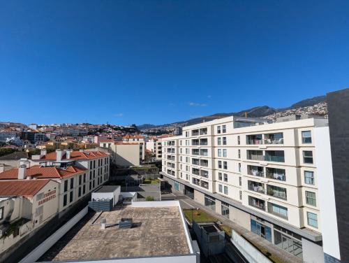 an aerial view of buildings in a city at Top-Floor One-Bedroom Flats - Peaceful with Ocean and City Views in Funchal