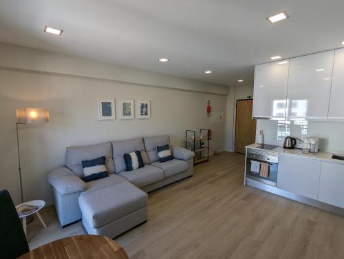 a living room with a couch and a kitchen at Top-Floor One-Bedroom Flats - Peaceful with Ocean and City Views in Funchal