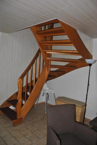 a wooden staircase in a living room with a couch at Ferienhaus Uferstraße in Wittmund