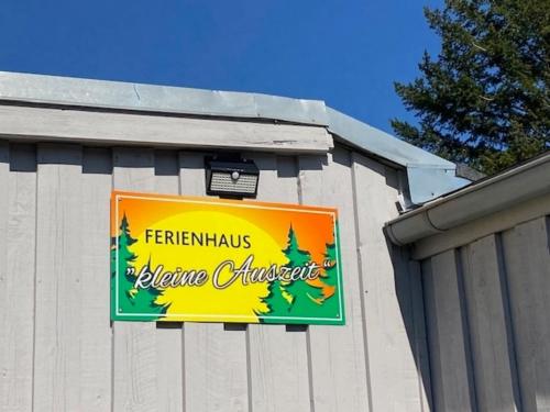 a sign on the side of a building at Ferienhaus "kleine Auszeit" gern auch mit Hund in Stiege