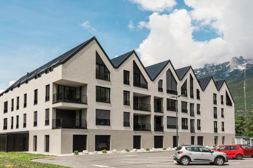 a large white building with a black roof at Nomad 27 in Bovec