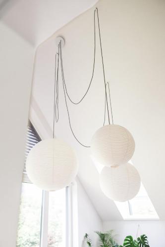 two white lights hanging from the ceiling in a room at Nomad 27 in Bovec