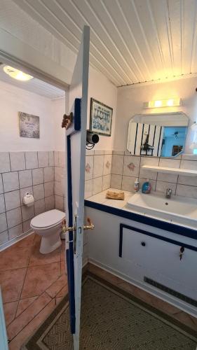 a bathroom with a tub and a sink and a toilet at Appartement 24 in Kappeln