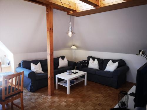 a living room with two couches and a table at Harmonie in Prerow