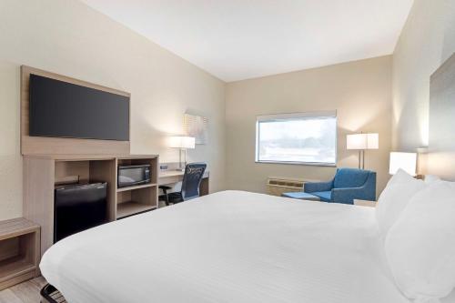 a hotel room with a bed and a flat screen tv at Best Western of Wise in Wise