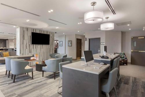 a lobby with chairs and a desk with a computer at Executive Residency by Best Western Toronto-Mississauga in Mississauga