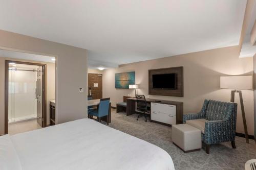 a hotel room with a bed and a desk and chair at Executive Residency by Best Western Toronto-Mississauga in Mississauga