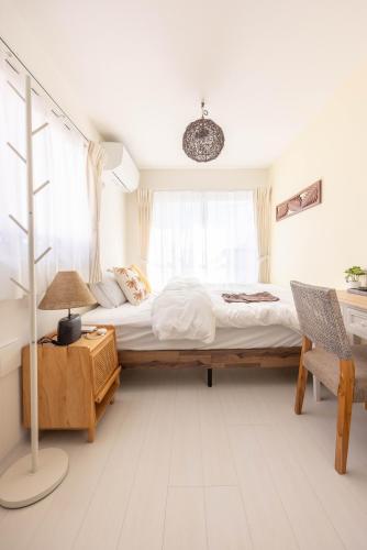 a bedroom with a large bed and a chair at Cloud Nine Apartment Sky Tree in Tokyo