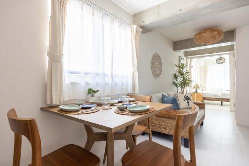 a dining room with a wooden table and chairs at Cloud Nine Apartment Sky Tree in Tokyo