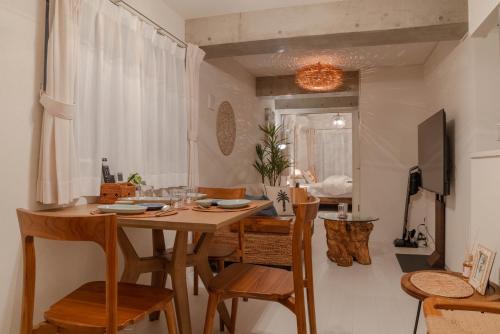 a dining room with a wooden table and chairs at Cloud Nine Apartment Sky Tree in Tokyo