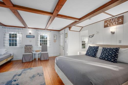 a bedroom with a large bed and a table at Seaside Cottages - Cottage 26 - Williams Port in South Yarmouth