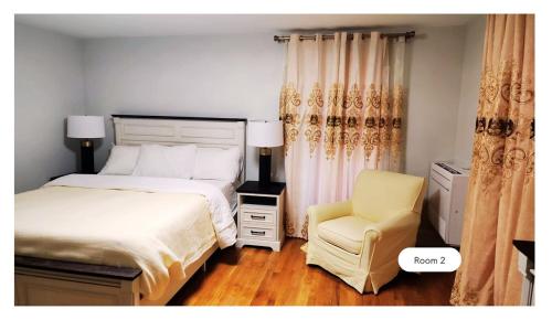a bedroom with a bed and a yellow chair at Gorgeous 2nd Floor Home with Private Entry in Canton