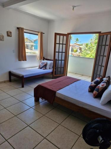 Ένα ή περισσότερα κρεβάτια σε δωμάτιο στο Casa para família a 150m da Praia do Perequê Açu