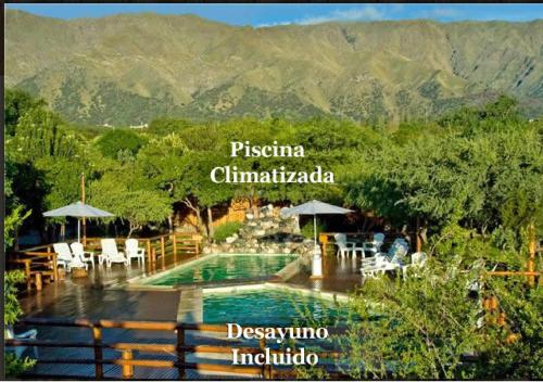 a view of a swimming pool with mountains in the background at Rincón de los Troncos in Merlo