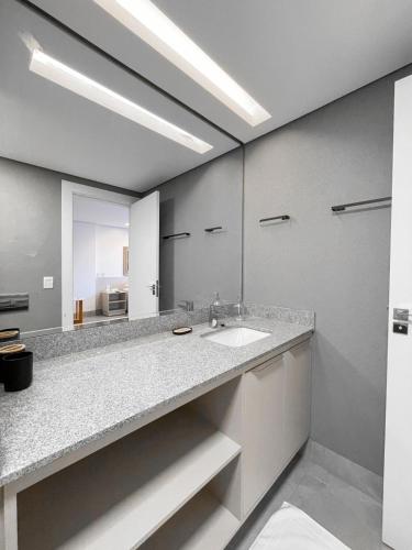a bathroom with a sink and a large mirror at Luxury Collection - The Journey in Campo Grande
