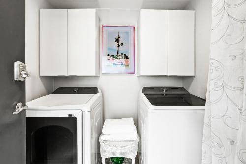 a white laundry room with a washer and dryer at Beach Rd, 300ft to Beach Access & 500ft to Siesta Key Village, 2bdr in Siesta Key