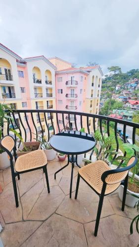 a patio with a table and chairs on a balcony at Highland Stays at Mines View in Baguio