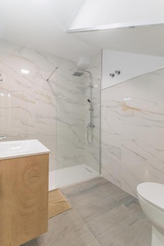 a bathroom with a shower and a sink and a toilet at Playa de las Mujeres in San Bartolomé