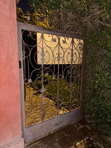 a door with an iron gate in front of a building at Elegant apartment with garden in Sheikh Zayed