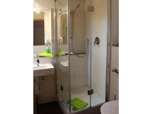 a bathroom with a glass shower and a sink at with mountain view Comfortable holiday residence in Brannenburg