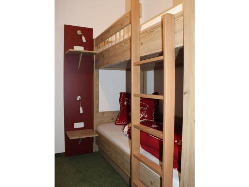 a bedroom with a bunk bed with a ladder at with mountain view Comfortable holiday residence in Brannenburg