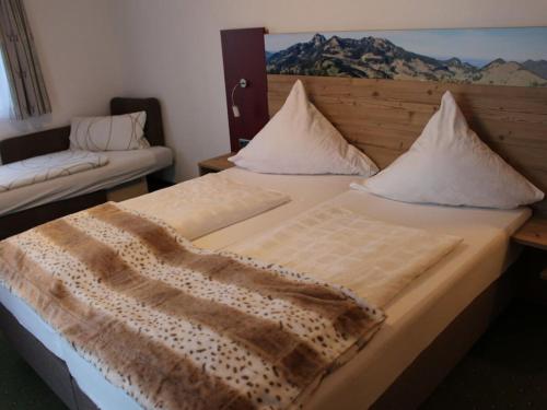 a bedroom with a bed with a blanket on it at with mountain view Comfortable holiday residence in Brannenburg