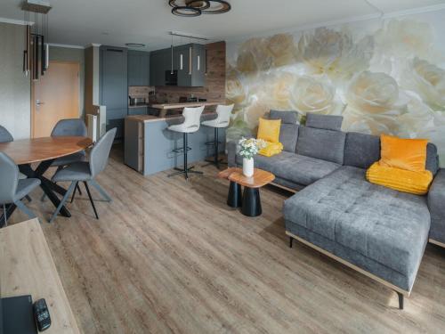 a living room with a couch and a table at Island happiness Comfortable holiday residence in Norderney