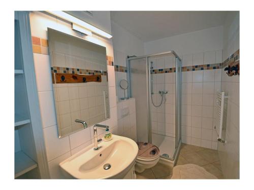 a bathroom with a sink and a shower at Beach Dune Comfortable holiday residence in Juliusruh