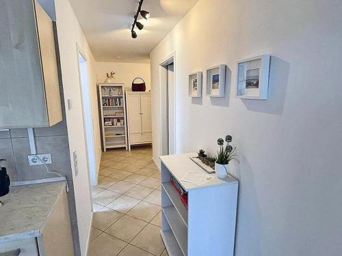a kitchen with a white counter top and a room at Beach Dune Comfortable holiday residence in Juliusruh