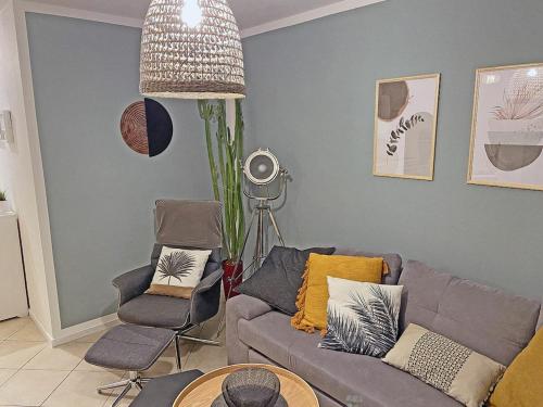 a living room with a couch and a chair at Beach Dune Comfortable holiday residence in Juliusruh