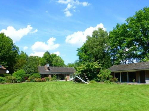 a house with a large lawn in front of it at Garden view Comfortable holiday residence in Westerstede