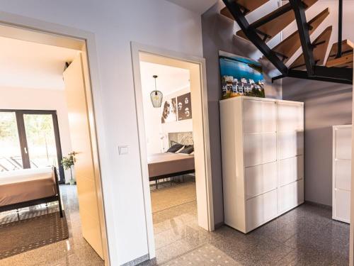 a room with a bedroom with a bed and a mirror at Lagunenhaus Joy Comfortable holiday residence in Kahnsdorf