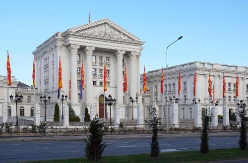 a large white building with red and orange flags at LION Apartments - DEBAR MAALO in Skopje