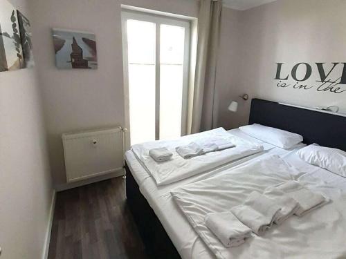 a bedroom with a bed with towels on it at Koehler 2 Buskam 23 in Göhren